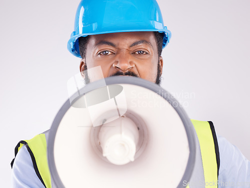 Image of Engineering black man, megaphone and construction in studio portrait for angry shouting by white background. Engineer, architect or manager with loudspeaker in workplace with anger on frustrated face