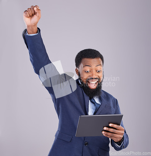 Image of Winner black man on tablet isolated on gray background for stock market, trading and business bonus, fist pump and success. Yes, wow and power of person with winning news or digital profit in studio