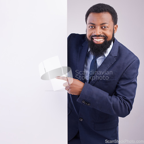 Image of Business portrait, black man and pointing to board in studio, white background and mockup space. Happy corporate worker, model and advertising poster, marketing news sign and brand on mock up banner