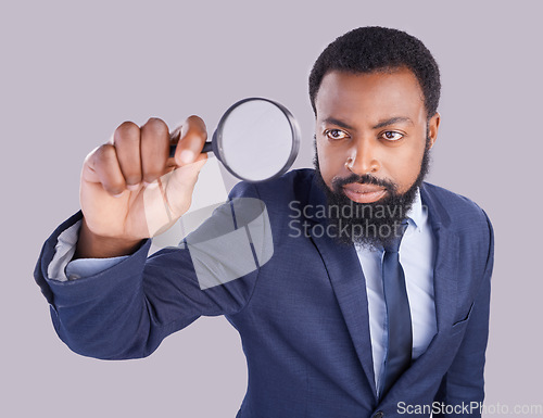 Image of Business black man, magnifying glass and studio with focus for quality inspection, compliance and stop fraud. Businessman, inspector and auditor at company with attention for financial health at job