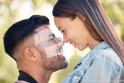 Image of Face, smile and a couple in the garden together, feeling happy while dating for romance in summer. Love, park or spring with a man and woman bonding outside in nature as a romantic partnership