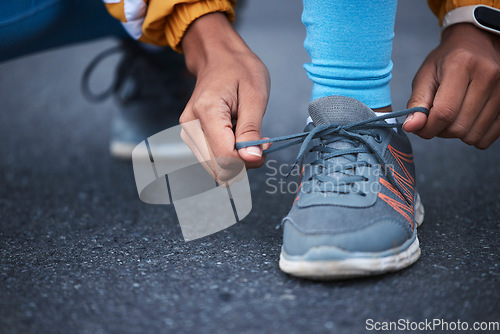 Image of Woman, hands or shoelace tie in fitness training, exercise or start cardio workout, wellness or athlete sports. Zoom, laces or running shoes for runner on road, city street or outdoor marathon