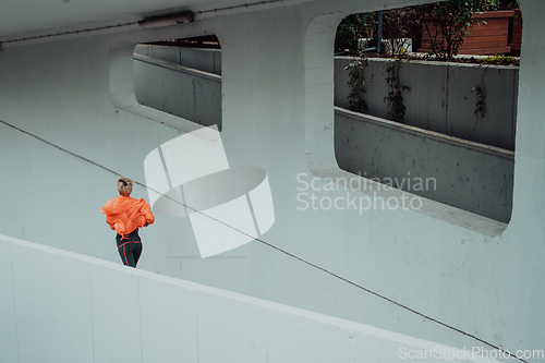 Image of Women in sports clothes running in a modern urban environment. The concept of a sporty and healthy lifestyle