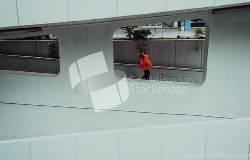 Image of Women in sports clothes running in a modern urban environment. The concept of a sporty and healthy lifestyle