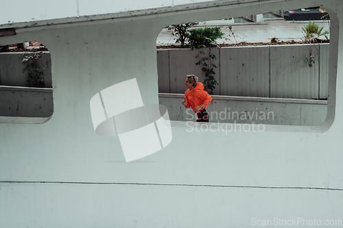 Image of Women in sports clothes running in a modern urban environment. The concept of a sporty and healthy lifestyle