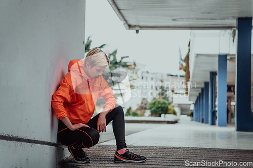 Image of Young smiling female resting after an active fitness training