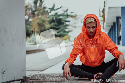 Image of Young smiling female resting after an active fitness training