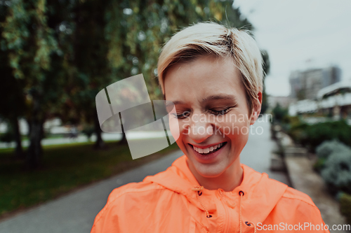 Image of A blonde in a sports outfit is running around the city in an urban environment. The hot blonde maintains a healthy lifestyle.