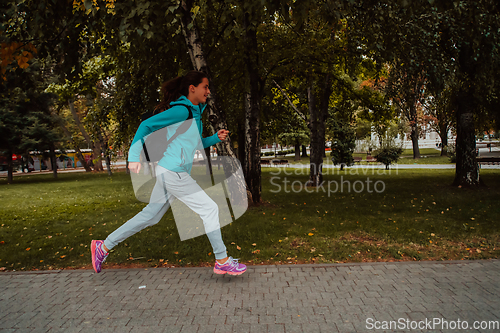 Image of Women in sports clothes running in a modern urban environment. The concept of a sporty and healthy lifestyle