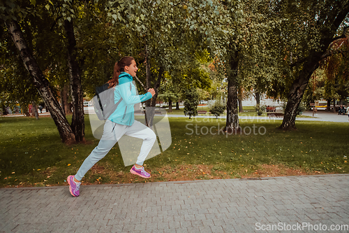 Image of Women in sports clothes running in a modern urban environment. The concept of a sporty and healthy lifestyle