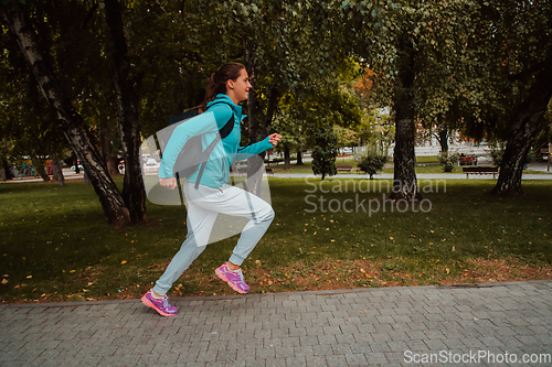 Image of Women in sports clothes running in a modern urban environment. The concept of a sporty and healthy lifestyle