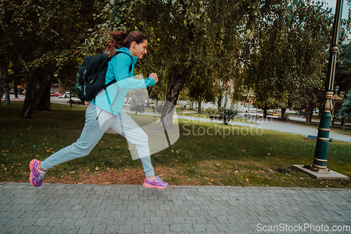 Image of Women in sports clothes running in a modern urban environment. The concept of a sporty and healthy lifestyle