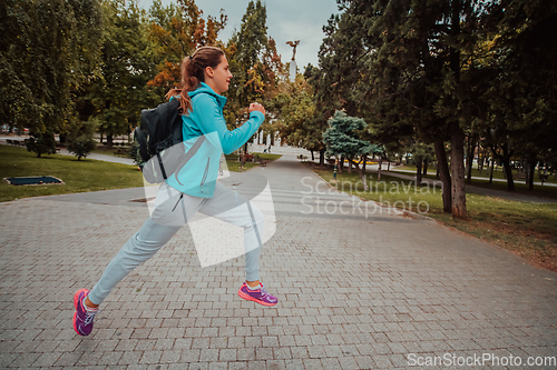 Image of Women in sports clothes running in a modern urban environment. The concept of a sporty and healthy lifestyle