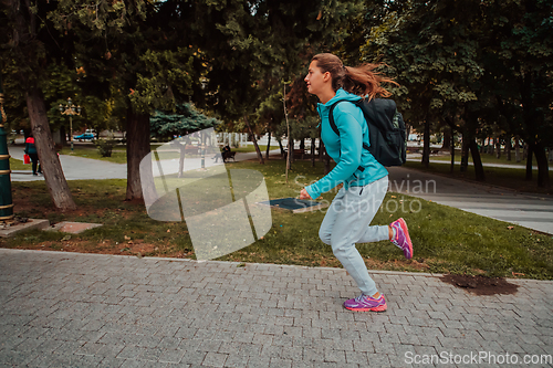 Image of Women in sports clothes running in a modern urban environment. The concept of a sporty and healthy lifestyle