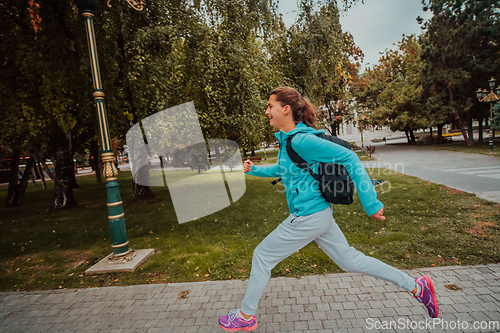 Image of Women in sports clothes running in a modern urban environment. The concept of a sporty and healthy lifestyle