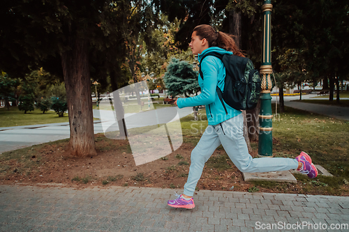 Image of Women in sports clothes running in a modern urban environment. The concept of a sporty and healthy lifestyle