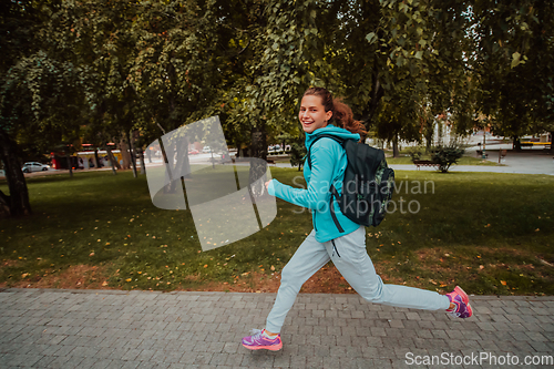 Image of Women in sports clothes running in a modern urban environment. The concept of a sporty and healthy lifestyle