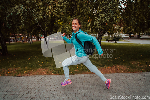 Image of Women in sports clothes running in a modern urban environment. The concept of a sporty and healthy lifestyle