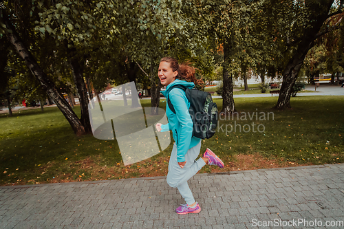 Image of Women in sports clothes running in a modern urban environment. The concept of a sporty and healthy lifestyle