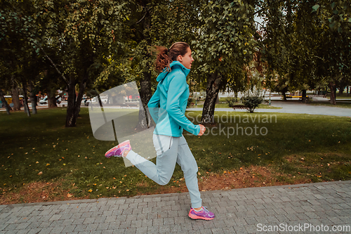 Image of Women in sports clothes running in a modern urban environment. The concept of a sporty and healthy lifestyle