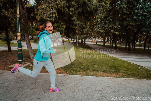 Image of Women in sports clothes running in a modern urban environment. The concept of a sporty and healthy lifestyle