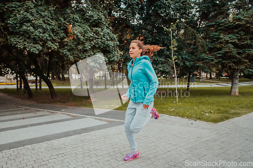 Image of Women in sports clothes running in a modern urban environment. The concept of a sporty and healthy lifestyle