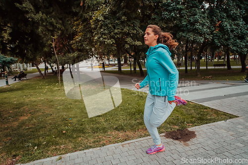 Image of Women in sports clothes running in a modern urban environment. The concept of a sporty and healthy lifestyle