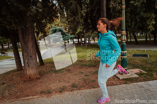 Image of Women in sports clothes running in a modern urban environment. The concept of a sporty and healthy lifestyle