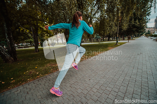 Image of Women in sports clothes running in a modern urban environment. The concept of a sporty and healthy lifestyle