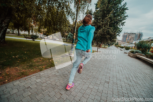 Image of Women in sports clothes running in a modern urban environment. The concept of a sporty and healthy lifestyle