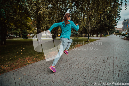 Image of Women in sports clothes running in a modern urban environment. The concept of a sporty and healthy lifestyle