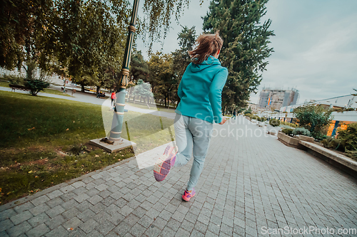 Image of Women in sports clothes running in a modern urban environment. The concept of a sporty and healthy lifestyle