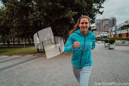 Image of Women in sports clothes running in a modern urban environment. The concept of a sporty and healthy lifestyle