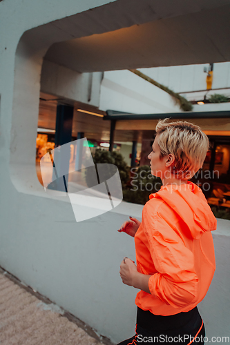 Image of Women in sports clothes running in a modern urban environment. The concept of a sporty and healthy lifestyle