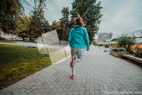 Image of Women in sports clothes running in a modern urban environment. The concept of a sporty and healthy lifestyle