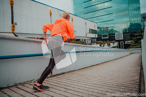 Image of Women in sports clothes running in a modern urban environment. The concept of a sporty and healthy lifestyle