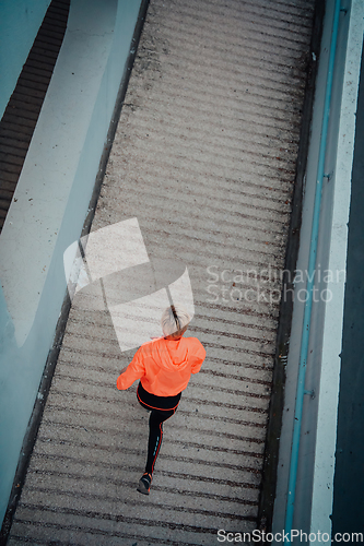 Image of Top view photo of omen in sports clothes running in a modern urban environment. The concept of a sporty and healthy lifestyle