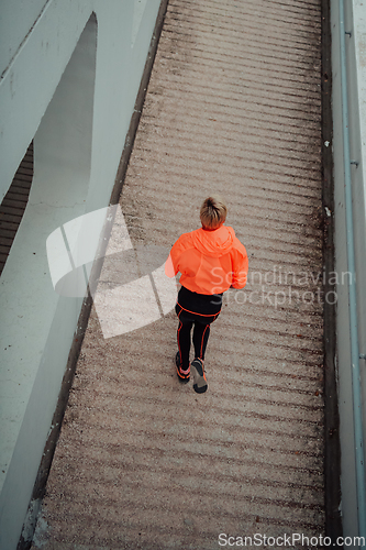 Image of Top view photo of omen in sports clothes running in a modern urban environment. The concept of a sporty and healthy lifestyle