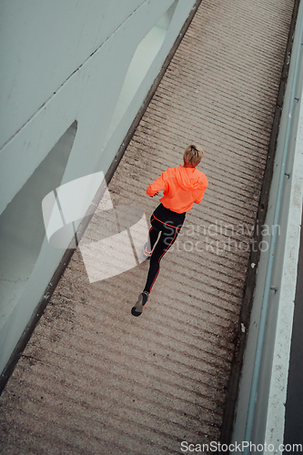 Image of Top view photo of omen in sports clothes running in a modern urban environment. The concept of a sporty and healthy lifestyle