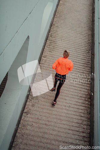 Image of Top view photo of omen in sports clothes running in a modern urban environment. The concept of a sporty and healthy lifestyle