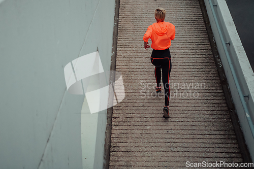 Image of Top view photo of omen in sports clothes running in a modern urban environment. The concept of a sporty and healthy lifestyle