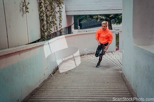 Image of Women in sports clothes running in a modern urban environment et night time. The concept of a sporty and healthy lifestyle