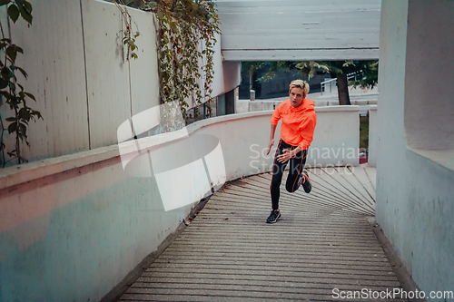 Image of Women in sports clothes running in a modern urban environment et night time. The concept of a sporty and healthy lifestyle