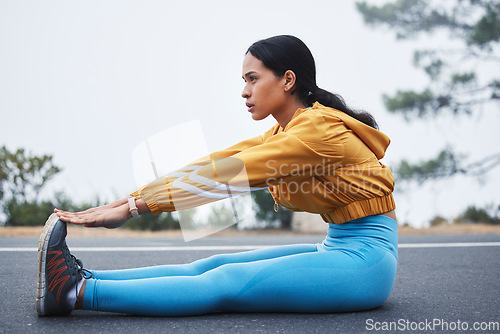 Image of Sports, leg stretching and woman runner doing exercise on a outdoor road feeling serious. Workout, running training and wellness warm up of young female ready for sports and marathon run in mist