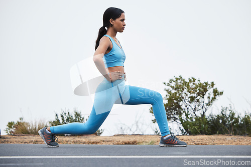 Image of Legs stretching, woman profile and runner exercise on a outdoor road with concentration. Workout warm up, running training and wellness of a young female ready for sports and marathon run in mist
