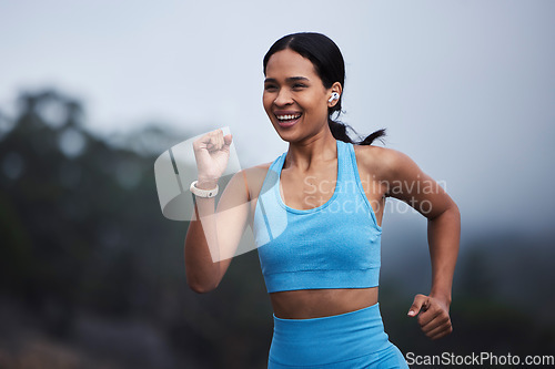 Image of Running, fitness and happy woman in nature with cardio training, exercise goals or fast challenge for progress. Sports, morning fog and runner or young person jogging and listening to music outdoor