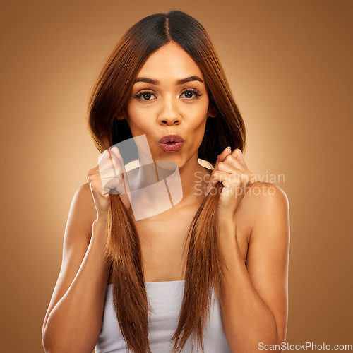 Image of Haircare, shock and portrait of woman with hair in hands, strong texture and salon shine in studio. Happy model, mockup and beauty, healthy straight hairstyle and keratin product on brown background.