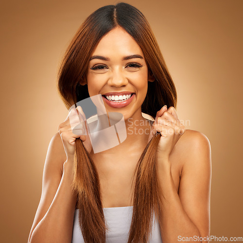 Image of Haircare, happiness and portrait of woman with hair in hands, strong texture and salon shine in studio. Happy model with smile, mockup and beauty, healthy straight hairstyle on brown background space