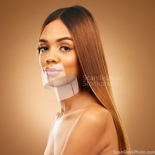 Image of Beauty, hair care and portrait of serious woman in studio for growth, color shine or healthy texture. Aesthetic female model for haircare, natural makeup and hairdresser or salon on brown background
