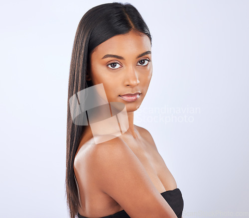 Image of Indian woman, hair care or face in studio portrait for beauty, healthy natural shine or wellness. Beautiful glowing young girl model, self love or salon cosmetics in grooming on white background